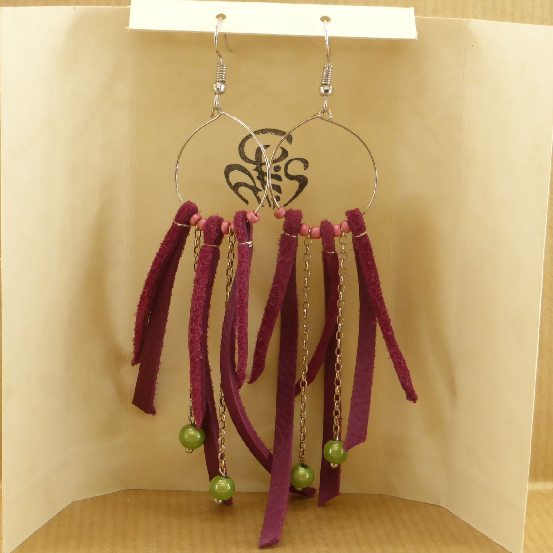 Purple leather strap earrings on metal ring and green beads on chain