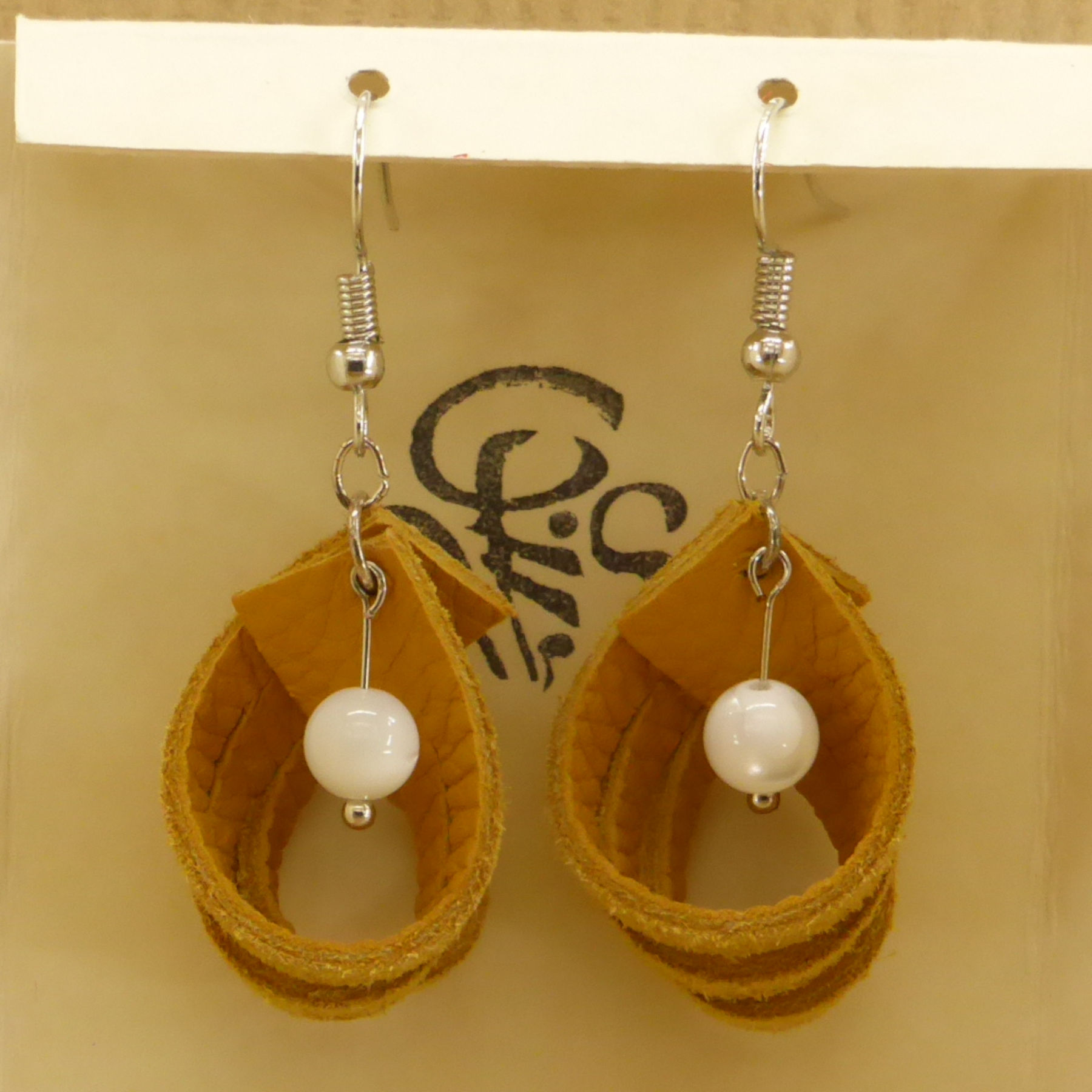 Yellow leather earring with 3 coiled bands and mother-of-pearl