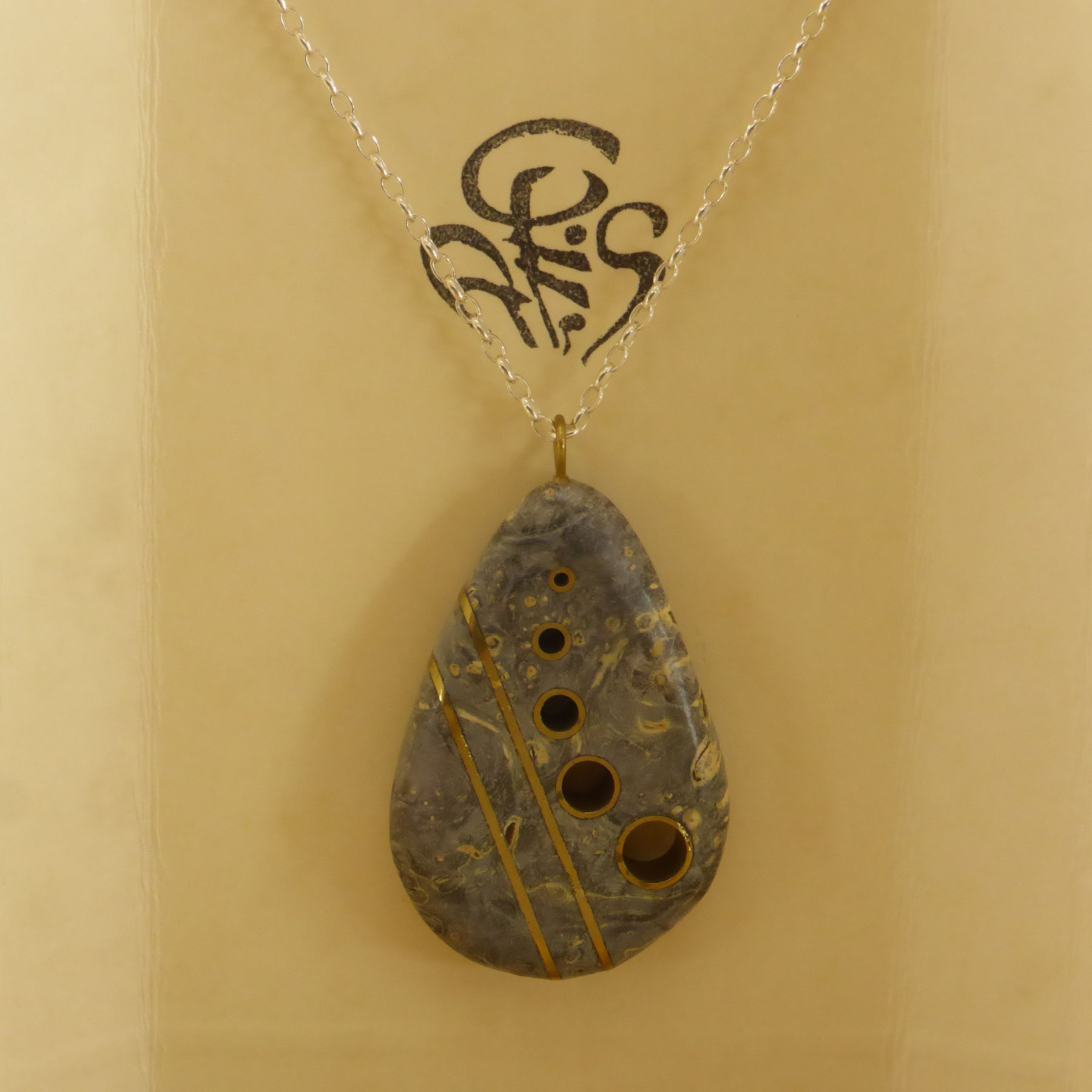 Black stabilized maple burl pendant with brass motifs